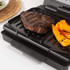 Black electric grill shown open, highlighting ridged non-stick plates.