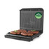 Open black electric grill with cooked steaks, PFAS free label on lid