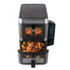 Black dual drawer air fryer with touchscreen, shown cooking chicken, potatoes, and carrots