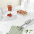 Silver and white handheld blender with detachable stainless steel blending arm