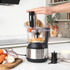 Food processor blending chickpeas and veg, finger pressing button, close-up view