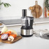 Black and stainless steel blender base, front view, power cord attached