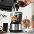 Stainless steel food processor shredding vegetables in a modern kitchen