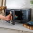 Black and gold Salter microwave oven, front view with control dials on the right.