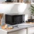Black microwave with open door showing interior and control panel