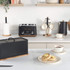 Salter matte black toaster, kettle, and bread bin on kitchen counter with cups and crumpets
