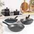 Set of Salter black-handled saucepans and frying pan in use, view from above