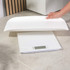White digital baby scale with curved tray, shown on a plain background