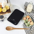 Black electronic kitchen scale in Salter packaging, 5 kg max weight, suitable for baking.