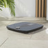 Black digital bathroom scales on tiled floor