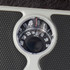 Mechanical bathroom scale with black textured platform, showing close-up of dial.