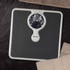 Mechanical bathroom scale with black textured surface, viewed from above.