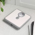 White mechanical bathroom scale with grey trim, shown on countertop