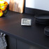 Silver Salter digital kitchen timer on black worktop, shown with black plates. Product image.