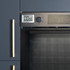 Digital kitchen timer attached to oven, shown in modern dark cabinetry.