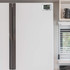 White fridge freezer with digital timer panel, shown closed in modern kitchen.