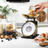 Salter mechanical kitchen scale in gold shown on product packaging
