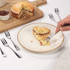Silver dessert fork with three prongs, shown on white background