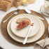 Breakfast setting with stoneware plate, bread with jam, and stainless steel cutlery