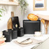 Black bread bin with loaf of bread, modern kitchen setting
