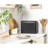 Black metal bread bin on kitchen worktop, shown in modern UK home setting