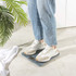 Grey digital bathroom scale with LCD display, angled view