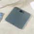 Grey digital bathroom scale with LCD display, angled view