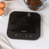 Black digital kitchen scale with clear display, shown on countertop