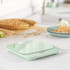 Digital kitchen scale in pale green on worktop, shown in a home baking scene