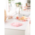 Glass mixing bowl with flour, butter and egg on pink digital kitchen scales, baking ingredients beside