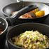 Salter non-stick grey frying pans shown with cooked food, angled for detail