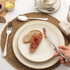 Slice of bread with jam on plate, hand holding knife, breakfast table setting