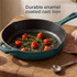 Green cast iron frying pan with roasted tomatoes and herbs on rustic wooden table