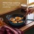 Green cast iron frying pan on hob with pancakes, hand flipping, kitchen scene