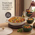 Cream casserole dish with lid, filled with baked meatballs in sauce, on kitchen counter