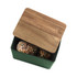 Green bread bin with wooden lid, holding seeded rolls