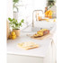 Yellow digital kitchen scale with glass bowl holding flour, butter, and egg; lemons and baking ingredients beside.