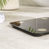 Black and gold digital bathroom scale on tiled floor
