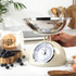 Cream mechanical kitchen scale with round dial, shown from above.