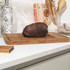 Rectangular wooden carving board with juice groove and textured centre