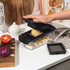 Black vegetable chopper with interchangeable grid blades and cleaning comb