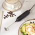 Black electric grooming device power button close-up