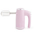 Pink hand mixer with chrome trim and beater attachments, side view
