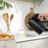 Black and gold electric kettle with water level indicator, shown side view.
