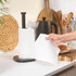 Kitchen paper towel roll on black holder, hand tearing sheet, modern kitchen counter