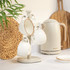 Four cream stoneware mugs on stand, with matching kettle, styled on kitchen worktop