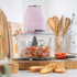 Pink Salter food chopper with glass bowl, shown upright for product listing.