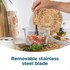 Glass food chopper bowl with chopped vegetables and herbs, top view