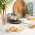 Digital kitchen scale with stainless steel bowl on worktop, suitable for baking or cooking