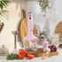 Pink hand blender set with chopper, whisk, and jug on kitchen counter